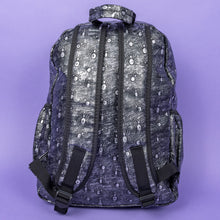 Load image into Gallery viewer, The Rustic Silver Spider Backpack sat on a purple background. The bag is facing away to highlight the two padded shoulder straps, the top handle and two elasticated side pockets. The vegan friendly faux leather bag has 3d embossed spiders in varying sizes with brushed black and silver tones all over.
