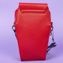 Load image into Gallery viewer, The GothX Red Mini Coffin Bag facing away on a purple background to highlight the plain back. The coffin bag is made with vegan friendly sleek red leather features a magnetic clip close flap with a zip compartment and detachable, adjustable strap.
