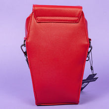 Load image into Gallery viewer, The GothX Red Mini Coffin Bag facing away on a purple background to highlight the plain back. The coffin bag is made with vegan friendly sleek red leather features a magnetic clip close flap with a zip compartment and detachable, adjustable strap.
