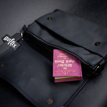 Load image into Gallery viewer, CHOK GothX black bag with silver skull and rose hardware, shown open to reveal an inner compartment with a magical spellbook peeking out.