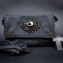 Load image into Gallery viewer, A black vegan leather bag by CHOK GothX with a metallic skull and rose detailing on the front flap, styled on a black backdrop with the gothx tag showing. The detachable adjustable strap is shown in front.