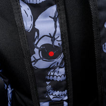 Load image into Gallery viewer, Close-up of skull with red eye on shoulder strap – Detailed view of the shoulder strap, showing a grey skull with a single red eye, enhancing the sinister, gothic theme of the backpack.