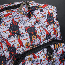Load image into Gallery viewer, Close-up of CHOK GothX's lucky cat print backpack showcasing the detailed lucky cat design in black, white, orange, and red. Features durable zips and a textured fabric finish. Ideal for unique, alternative styles.