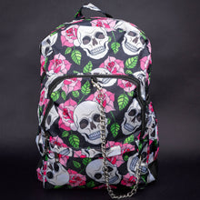 Load image into Gallery viewer, Full front view of skull and rose backpack with chain detail – The backpack’s front, showing the full print of white skulls, pink roses, and green leaves. A silver chain dangles from the front pocket zipper, adding a punk-inspired touch to the overall design.