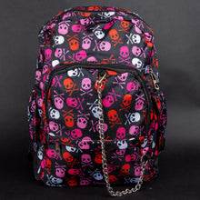 Load image into Gallery viewer, A front-angle shot of the CHOK GothX pink skull and crossbones backpack. The black nylon bag has bold skulls and crossbones, a silver chain detail, and compartments for laptops and organisation. Gothic yet functional, this is a must-have for alternative fashion.