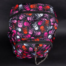Load image into Gallery viewer, Top view of the CHOK GothX pink skull and crossbones backpack with striking pink, red, and white skull graphics. Features include double zips, multiple front pockets, adjustable straps, and padded support. Perfect for carrying laptops and essentials in gothic style.