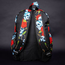 Load image into Gallery viewer, Back view of skull and rose backpack with black contrast – The back of the backpack features the skull and rose print on the shoulder straps, contrasting with the black material on the main body for a bold alternative aesthetic.