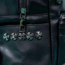 Load image into Gallery viewer, Close up of the GothX black cross vegan stud mini backpack on a teal background. The vegan leather bag is facing forwards to highlight the cross studs along the top zip line and top of zipped pocket, studded cross with chain centrepiece and side metal cross studs on the slot pockets.