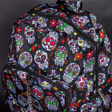 Load image into Gallery viewer, Angle view of the CHOK GothX Sugar Skull Backpack, showing its spacious design, double zips, and bold sugar skull print with bright floral accents. Ideal for carrying laptops, books, and essentials.