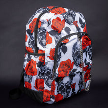 Load image into Gallery viewer, Side angle of white backpack with red rose and black skull pattern – Side view showcasing the spacious compartments of the backpack, adorned with black skulls and red roses for a dramatic, alternative style.