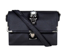 Load image into Gallery viewer, The GothX crystal skull vegan shoulder bag on a white studio background. The bag is facing forward to highlight the crystal skull centrepiece, metal clasp clip close, metal corner detailing and detachable strap.