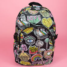 Load image into Gallery viewer, The kawaii graffiti doodle vegan backpack sat on a pink studio background. The bag is facing forward to highlight the two front zip pockets, two elastic side pockets and silver chain. The all over print has lollipops, pugs, rainbows, pizzas, polaroid cameras, eyes and fries.