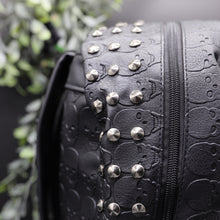 Load image into Gallery viewer, Close up of the gothx embossed skull vegan backpack main zip compartment to highlight the silver studded edge and all over embossed skull design.