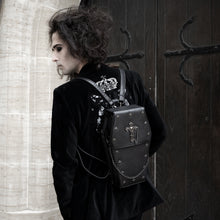 Load image into Gallery viewer, Sweeney wearing a goth outfit and the gothx coffin vegan backpack on their back. They are facing away from the camera to highlight the cross mini studs, cross and chain emblem and detachable silver chain.