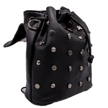 Load image into Gallery viewer, The GothX crystal skull vegan tassel tie backpack on a white studio background. The bag is facing forward angled right with the magnetic close clip flap open to highlight the tassel tie cords and cross, hexagon, cone and skull studs.