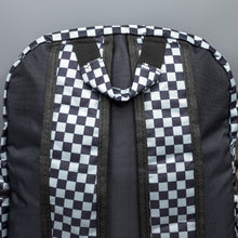 Load image into Gallery viewer, Close up of the Grey Checkerboard Backpack sat on a grey background. The vegan friendly bag is facing away from the camera to highlight the plain black back, the two side elasticated pockets, the top handle and the two adjustable padded shoulder straps.
