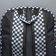 Load image into Gallery viewer, Close up of the Grey Checkerboard Backpack sat on a grey background. The vegan friendly bag is facing away from the camera to highlight the plain black back, the two side elasticated pockets, the top handle and the two adjustable padded shoulder straps.