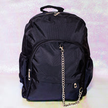 Load image into Gallery viewer, The black nylon vegan backpack with chain on an iridescent background. The bag is facing forward to highlight the two front zip pockets, two side pockets, double zip main compartment, top handle and detachable silver chain.
