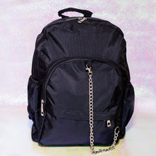 Load image into Gallery viewer, The black nylon vegan backpack with chain on an iridescent background. The bag is facing forward to highlight the two front zip pockets, two side pockets, double zip main compartment, top handle and detachable silver chain.