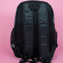 Load image into Gallery viewer, The black game over vegan backpack on a pink studio background. The bag is facing away to highlight the plain black back, side pockets, padded shoulder straps and top handle.