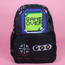 Load image into Gallery viewer, The black game over vegan backpack on a pink studio background. The bag is facing forward to highlight the front game boy inspired print with printed green game over screen and gaming button controls on the front zip pocket and side pockets.