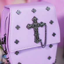Load image into Gallery viewer, Close up of the mini cross studs, cross chain centrepiece and the magnetic clip close of the GothX Pastel Lilac Mini Coffin Vegan Cross Body Bag.
