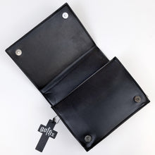 Load image into Gallery viewer, The GothX Ouija Spirit Book Mini Bag laying open on a white background to show the two magnetic clip closures, zipped middle and plain black vegan leather inside.