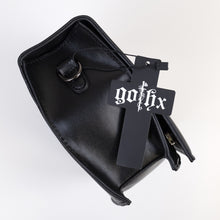 Load image into Gallery viewer, The GothX Ouija Spirit Book Mini Bag laying on its side on a white background to show the metal D ring on either side, the magnetic clip flap closure, zipped middle and plain black vegan leather side.
