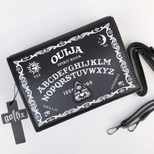Load image into Gallery viewer, The GothX Ouija Spirit Book Mini Bag sat on a white background. The bag is forward to highlight the ouija spirit book white printed detailing on the black book bag with the 3D planchette stitching. Next to the bag on the right is the adjustable detachable strap. Bag is inspired by witchy style and necromancy.