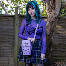 Load image into Gallery viewer, The GothX Pastel Lilac Mini Coffin Vegan Cross Body Bag being held up by a gothic alternative model. The vegan friendly pastel leather bag is facing forward to highlight the cross studs, cross & chain centrepiece, detachable chain and detachable adjustable shoulder strap.