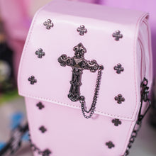 Load image into Gallery viewer, Close up of the mini cross studs, cross chain centrepiece and the magnetic clip close of the GothX Pastel Pink Mini Coffin Vegan Cross Body Bag.
