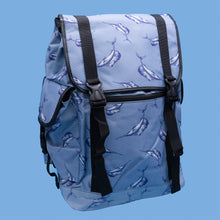 Load image into Gallery viewer, The Blue Swordfish Vegan backpack on a blue studio background. A pastel blue backpack with black buckle and strap detailing with swordfish printed all over. The bag is facing forward open to highlight the side buckle pockets, drawstring and buckle close and black piping detailing.