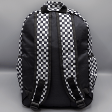 Load image into Gallery viewer, The White Checkerboard Backpack sat on a grey background. The vegan friendly bag features an all over mini black and white check print with black trim along the silver zips. The bag is facing away from camera to highlight the plain black back, the top handle and adjustable padded shoulder straps.
