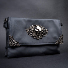 Load image into Gallery viewer, Side profile of a black vegan leather gothic bag by CHOK GothX showcasing its edgy skull embellishments and premium texture.
