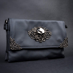 Side profile of a black vegan leather gothic bag by CHOK GothX showcasing its edgy skull embellishments and premium texture.