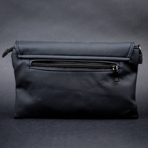 Rear view of CHOK GothX’s alternative black crossbody bag showing a zippered compartment for secure storage against a dark backdrop.