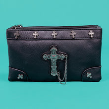Load image into Gallery viewer, The gothx dont cross me vegan clutch bag sat on a teal background. The clutch is facing forward to highlight the top zip compartment, cross studs and stud and the chain cross centrepiece.
