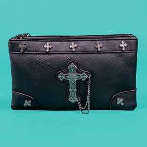 The gothx dont cross me vegan clutch bag sat on a teal background. The clutch is facing forward to highlight the top zip compartment, cross studs and stud and the chain cross centrepiece.