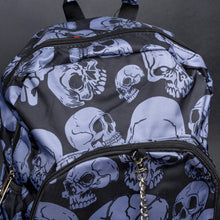 Load image into Gallery viewer, Side view of grey skull backpack with multiple compartments – Side angle displaying the spacious compartments, each covered in the grey skull design, perfect for an alternative style statement.
