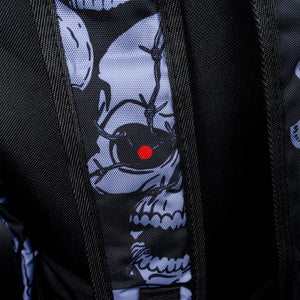 Close-up of skull with red eye on shoulder strap – Detailed view of the shoulder strap, showing a grey skull with a single red eye, enhancing the sinister, gothic theme of the backpack.