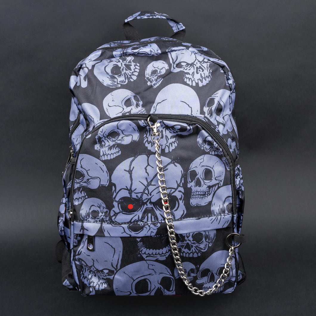 Full front view of grey skull backpack with chain and red eye detail – The complete front view of the backpack, showing the unique grey skulls against a dark background, accented with a silver chain and a bold red eye on one skull for an added gothic edge.
