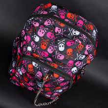 Load image into Gallery viewer, A gothic backpack by CHOK GothX featuring a vibrant pink skull and crossbones print in pink, red, and white on a black background. It has multiple compartments, padded adjustable straps, and edgy silver chain detailing. Designed for laptops up to 15 inches, this bag is durable, spacious, and perfect for alternative fashion lovers.
