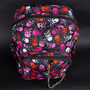 Top view of the CHOK GothX pink skull and crossbones backpack with striking pink, red, and white skull graphics. Features include double zips, multiple front pockets, adjustable straps, and padded support. Perfect for carrying laptops and essentials in gothic style.