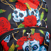 Load image into Gallery viewer, Close-up of front zip pocket with chain and skull rose pattern – A detailed look at the front pocket, displaying the blue skulls and red roses with golden vines, and the silver chain hanging from the zipper, enhancing the gothic style.
