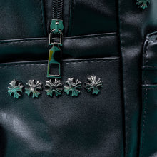 Load image into Gallery viewer, Close up of the GothX black cross vegan stud mini backpack on a teal background. The vegan leather bag is facing forwards to highlight the cross studs along the top zip line and top of zipped pocket, studded cross with chain centrepiece and side metal cross studs on the slot pockets.
