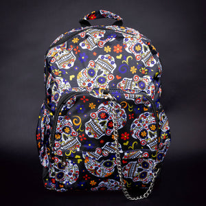 Full front view of sugar skull backpack with colourful floral designs – Full front view of the backpack, featuring a bright sugar skull design, festive floral patterns, and a chain accent on the zipper, making it a stand-out accessory.