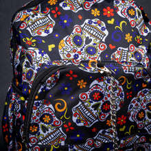 Load image into Gallery viewer, Close-up of sugar skull and chain detail on front pocket – Close-up of the front pocket, highlighting the detailed sugar skull and floral pattern with a silver chain accessory for an extra touch of flair.
