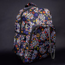 Load image into Gallery viewer, Side angle of sugar skull backpack with floral accents – Side view showing the colourful sugar skulls with intricate floral accents, creating a fun and artistic look.
