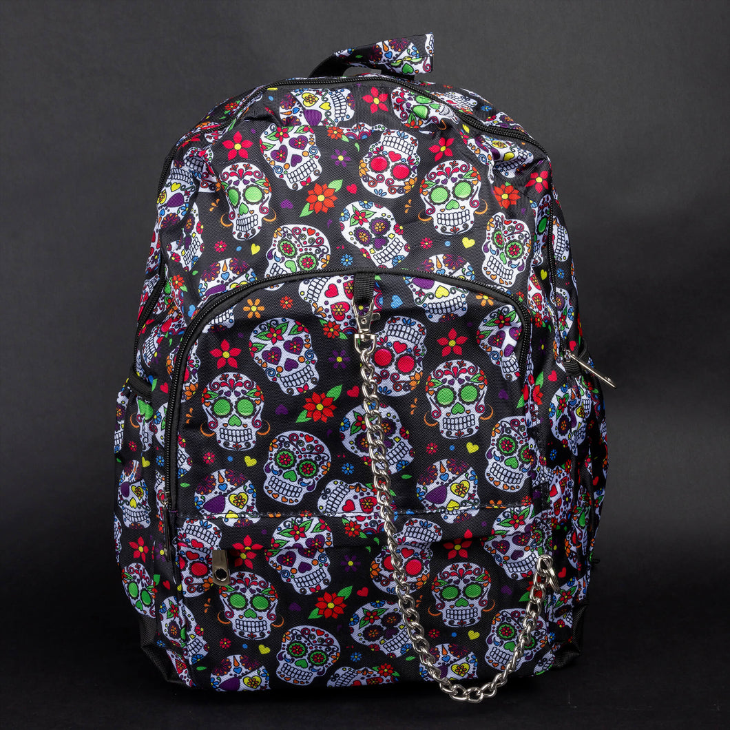 Front view of the CHOK GothX Sugar Skull Backpack, showcasing a bold sugar skull print on black nylon, silver chain detailing on the front pocket, and multiple zips for style and functionality. Perfect for gothic and alternative fashion lovers.