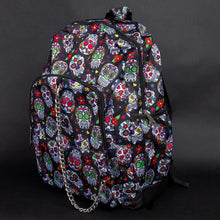 Load image into Gallery viewer, Side view of the CHOK GothX Sugar Skull Backpack, featuring its two side pockets, adjustable shoulder straps, and vibrant sugar skull print. Designed for both comfort and edgy style.
